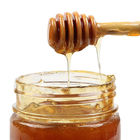Το ξύλινο φυσικό ξύλινο μέλι φραγμών παφλασμών μελιού κουταλιών Muddler μελιού ανακατώνει το φραγμό